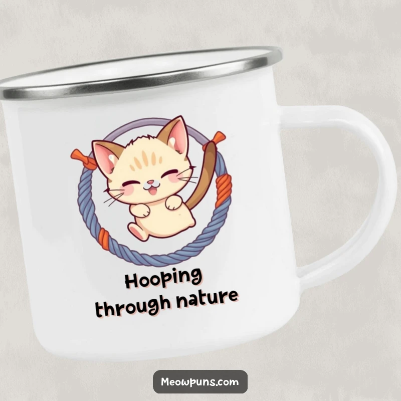 Funny mischievous Siamese cat jumping through a hoop of yarn, on a vintage-style enamel camping mug, for playful outdoor trips.