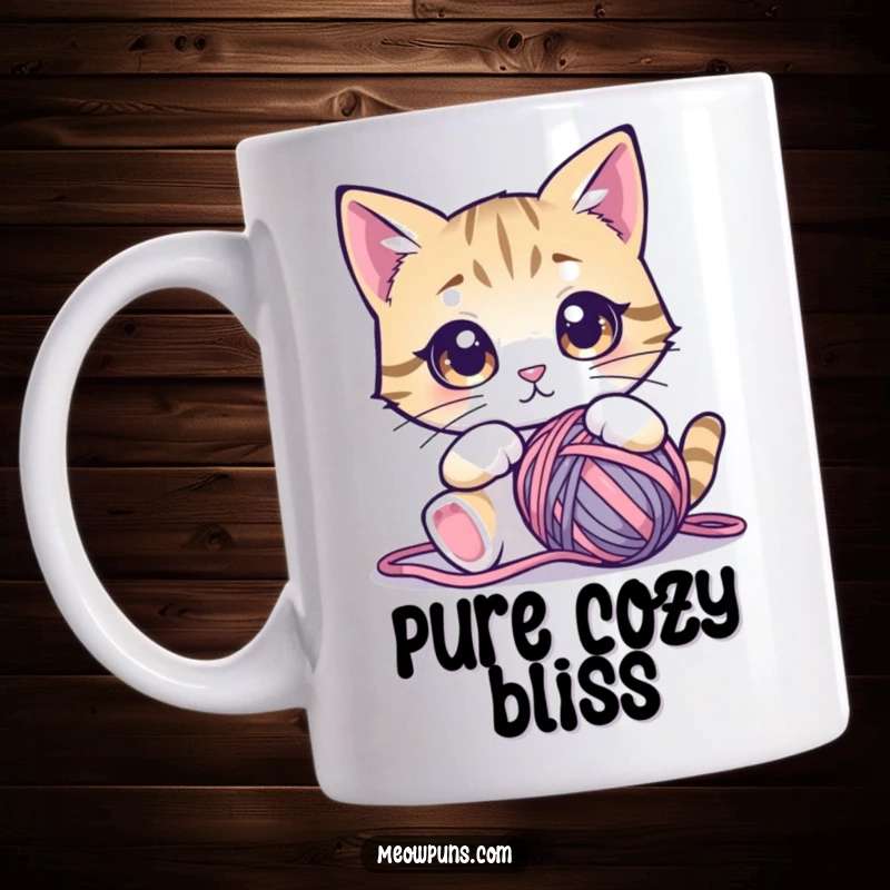 Funny cat mug showing a cute cat with huge, mesmerized eyes staring intently at a large ball of yarn.