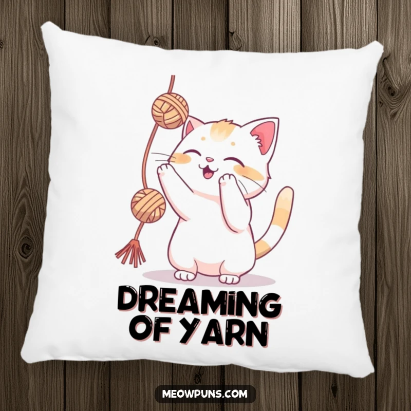 Funny cat playfully batting at a yarn ball on a pillow, offering cozy comfort and feline amusement.