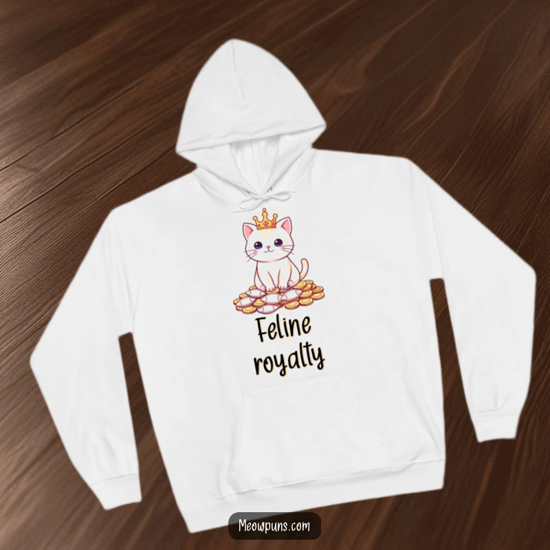 Funny hoodie featuring a cat wearing a tiny crown and sitting on fish-shaped coins, perfect for cozy feline royalty.