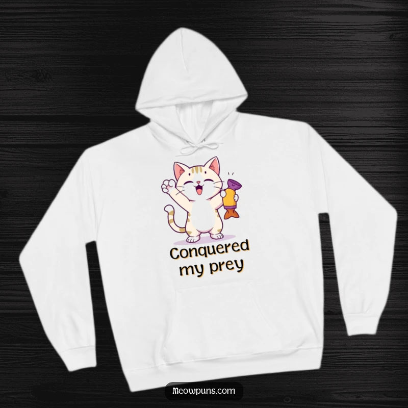 Funny cat hoodie featuring a cute cat in a triumphant pose after catching a toy, radiating a sense of victory.