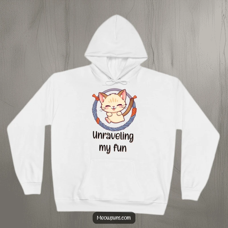 Funny mischievous Siamese cat jumping through a hoop of yarn, depicted on a warm hoodie, perfect for cozy and playful moments.