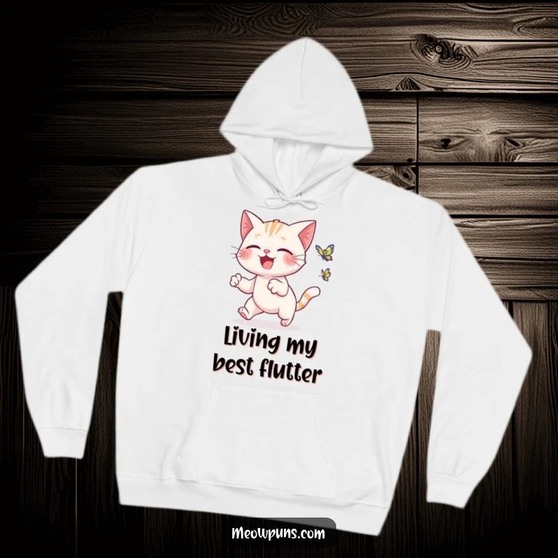 Funny cat hoodie depicting a cute cat gleefully chasing a small, animated butterfly, perfect for cozy, happy days.