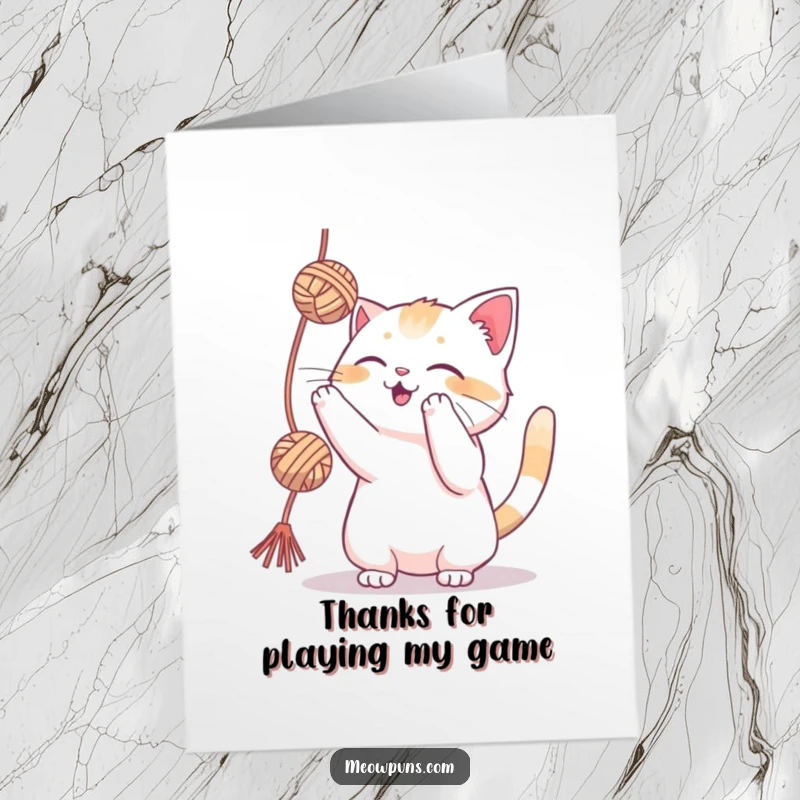 Funny Free Printable Thank You Card: A cat playfully batting a yarn ball, conveying gratitude with a happy expression.