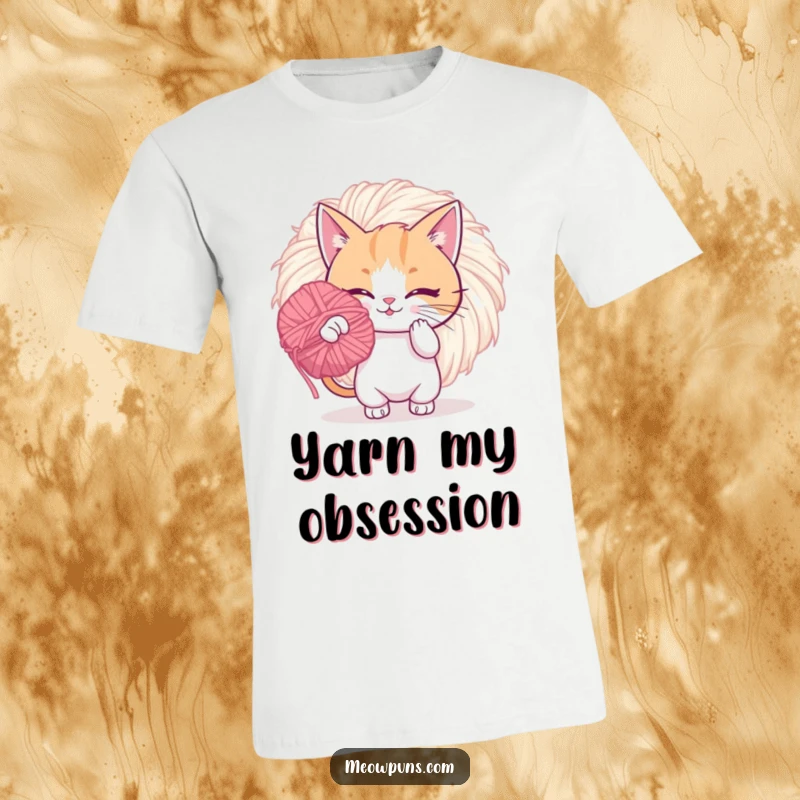 Funny t-shirt depicting a playful cat intensely batting at a giant, fuzzy yarn pom-pom, showcasing energetic feline fun.