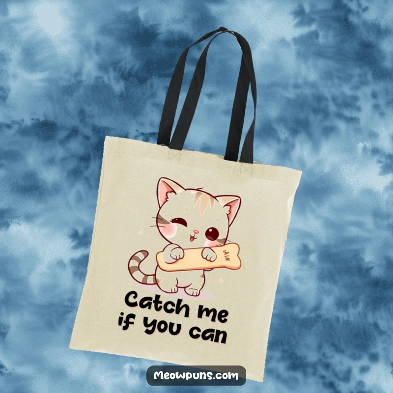 Funny tote bag illustrated with a cute cat character enthusiastically trying to grab a suspended fishbone, representing playful desire and everyday struggles.