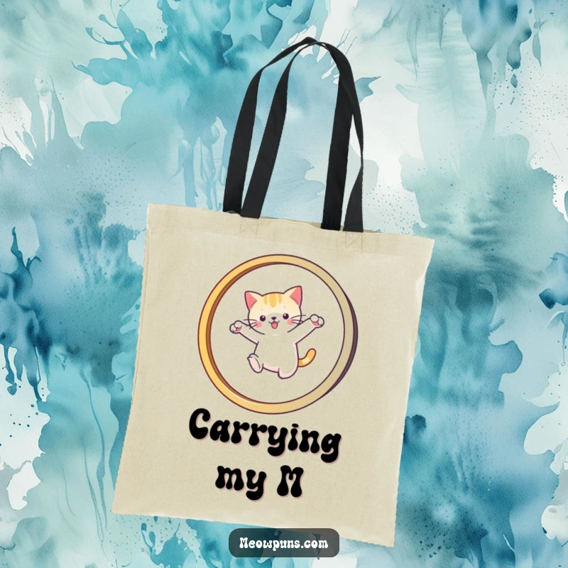 Funny tote bag showing a cat leaping through an 'M' hoop, perfect for carrying items with feline flair and humor.