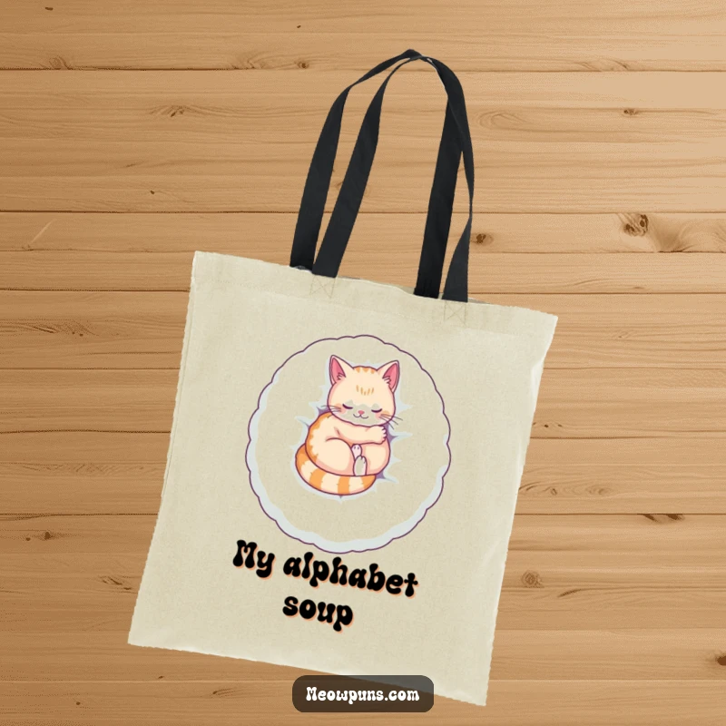 Funny tote bag showing a cat curled up on a giant plush letter, purring contentedly, perfect for carrying items with cozy humor.