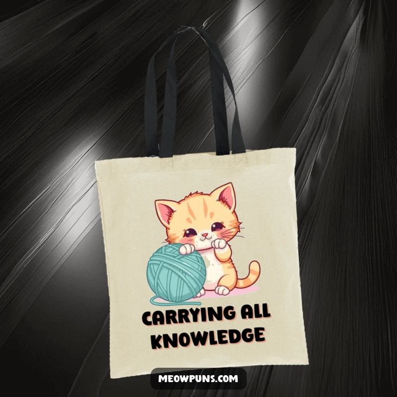 Funny tote bag with a playful kitten batting a giant letter-shaped yarn ball, ideal for carrying essentials with feline charm.